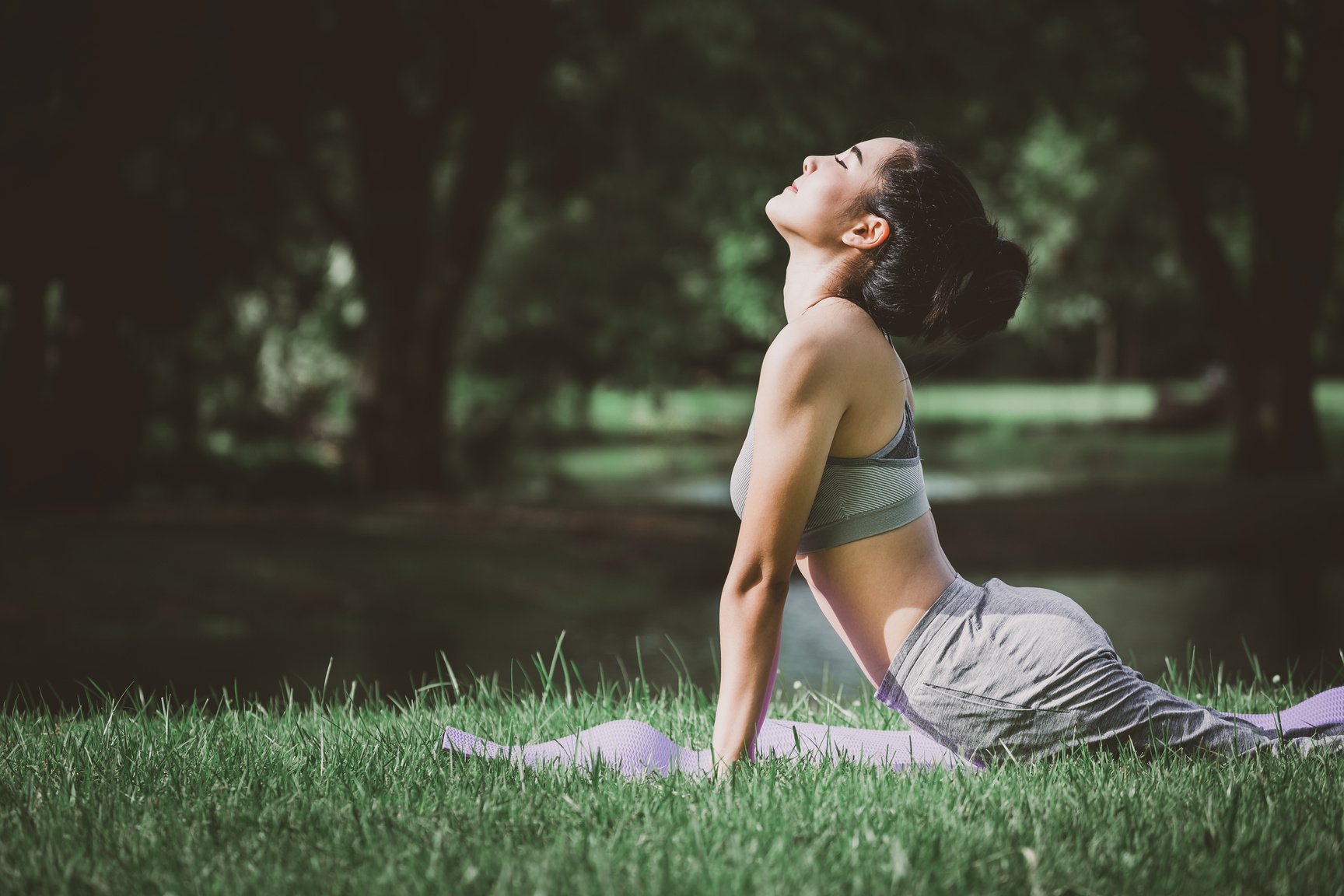 Fitness asian woman doing yoga in park